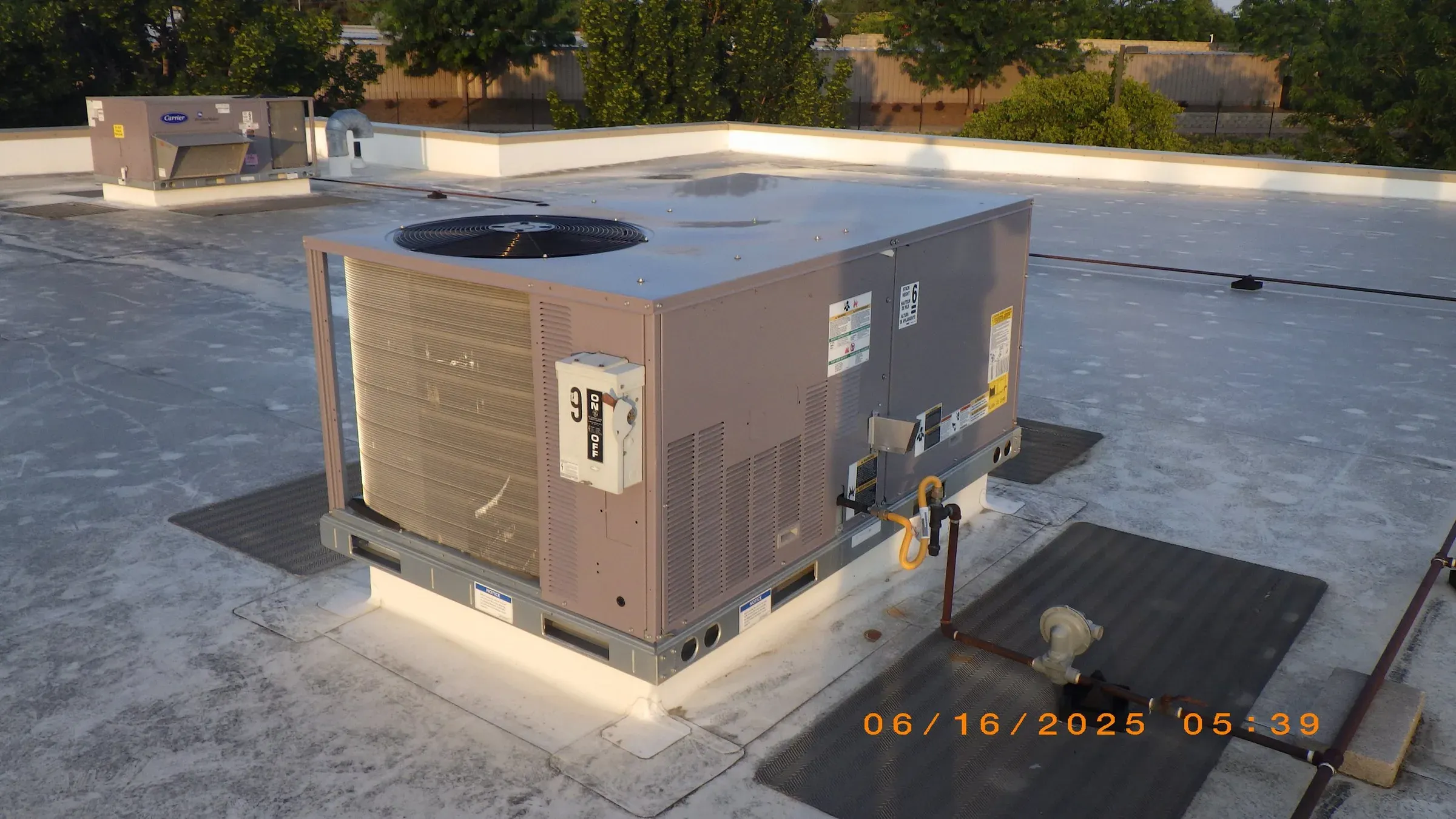 Rooftop HVAC unit inspected on a commercial building