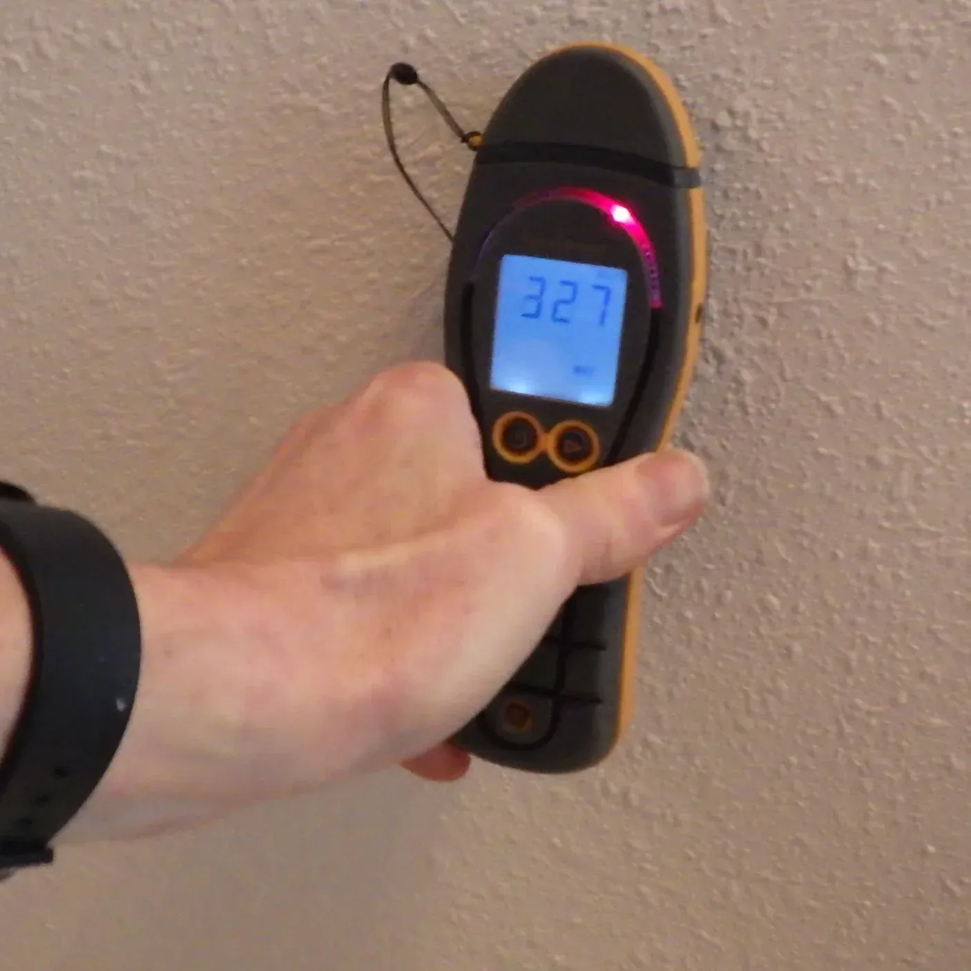 Inspector checking a wall with a moisture meter